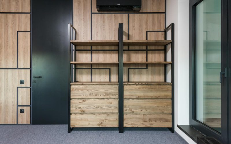 Contemporary interior design featuring wooden shelves and geometric patterns for home or office space.