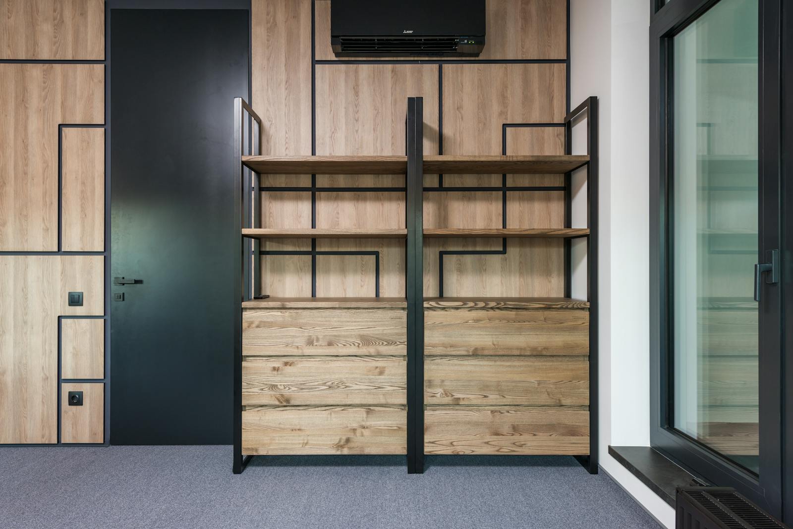 Contemporary interior design featuring wooden shelves and geometric patterns for home or office space.